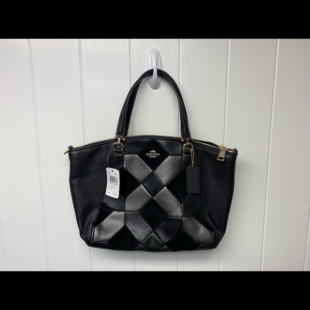 Brand new Coach pocketbook with tags.